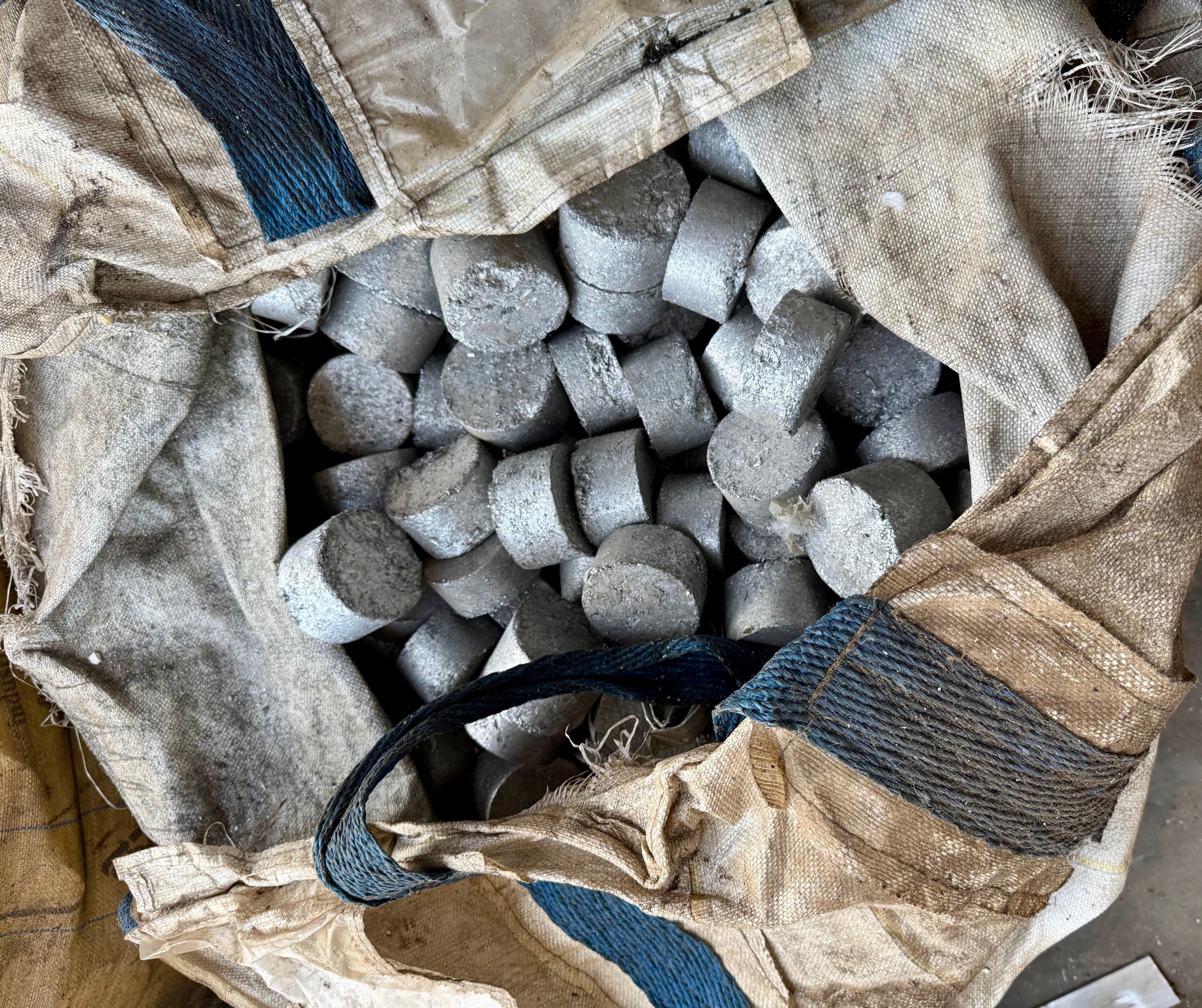 Aluminum briquettes stored in industrial recycling bags
