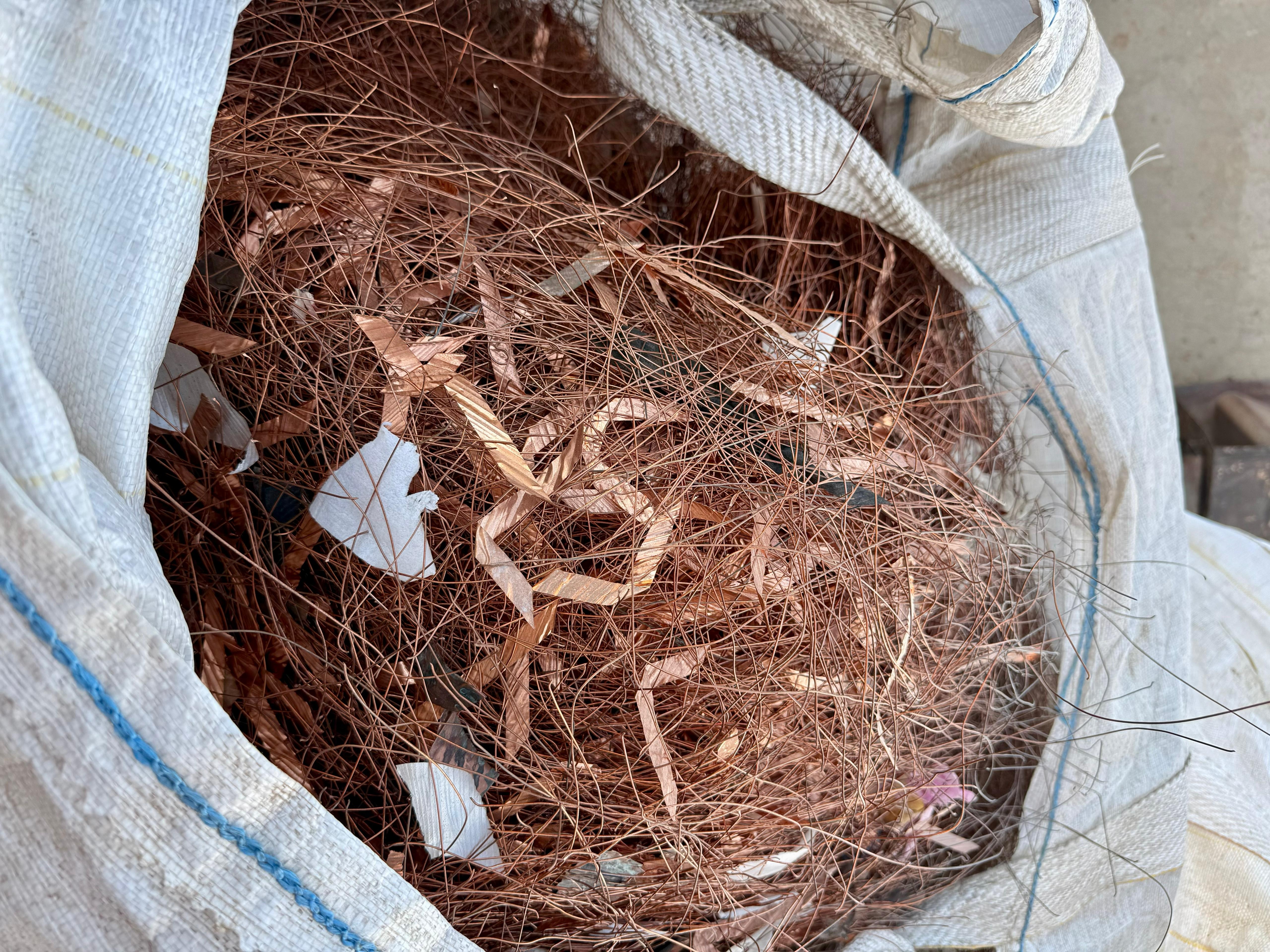 Mixed copper scrap wires collected in a large recycling bag