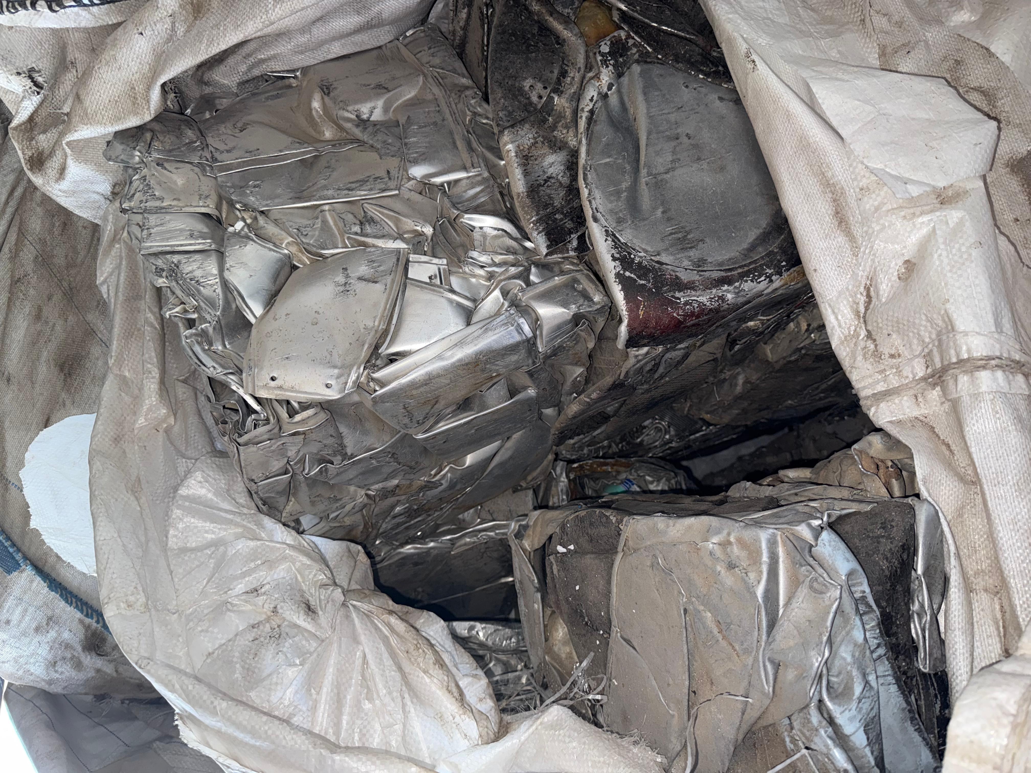 Compressed aluminum scrap blocks stored in industrial recycling bags